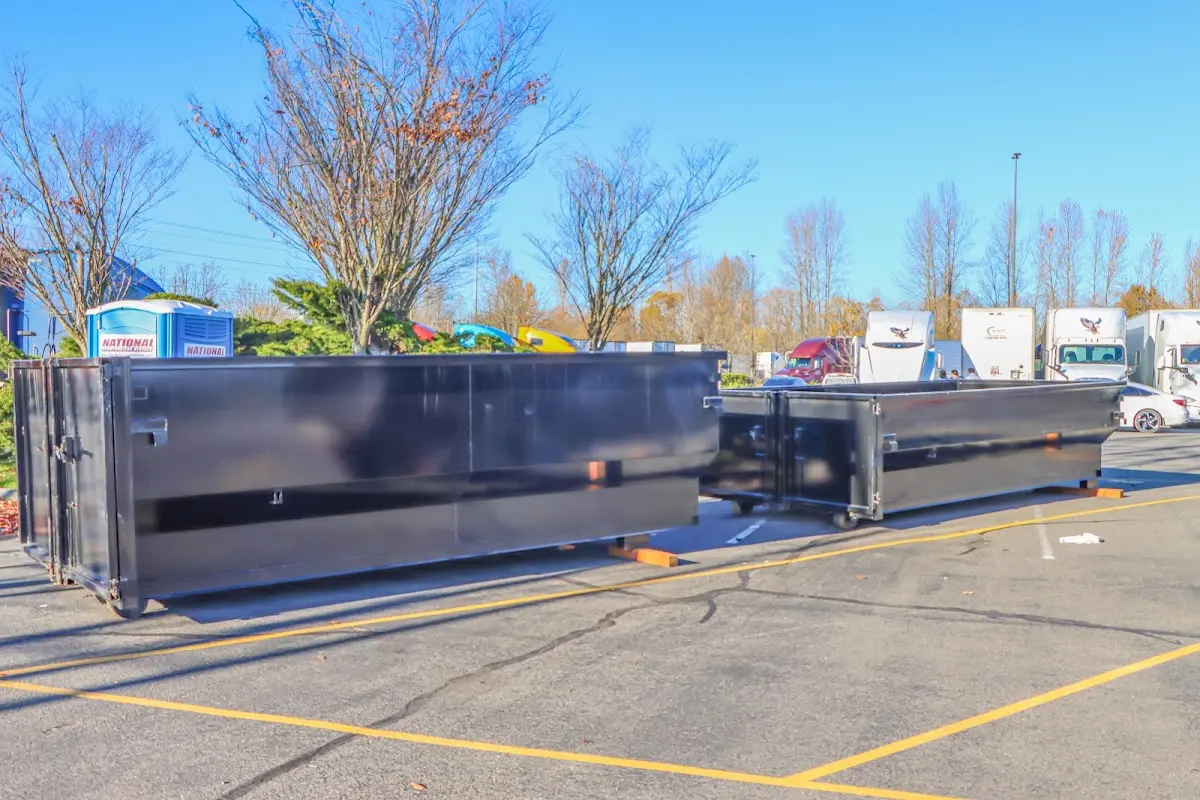 Professional dumpster rental service with roll-off container on residential driveway in Dinuba